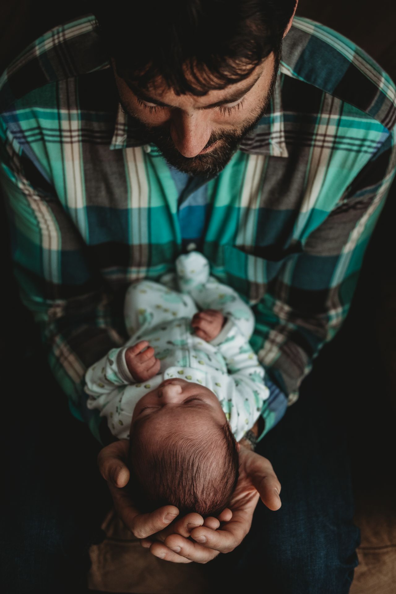Best Maternity and Newborn Photographer Washington DC Maryland Virginia new father gazing into newborn's eyes while cradled in hands