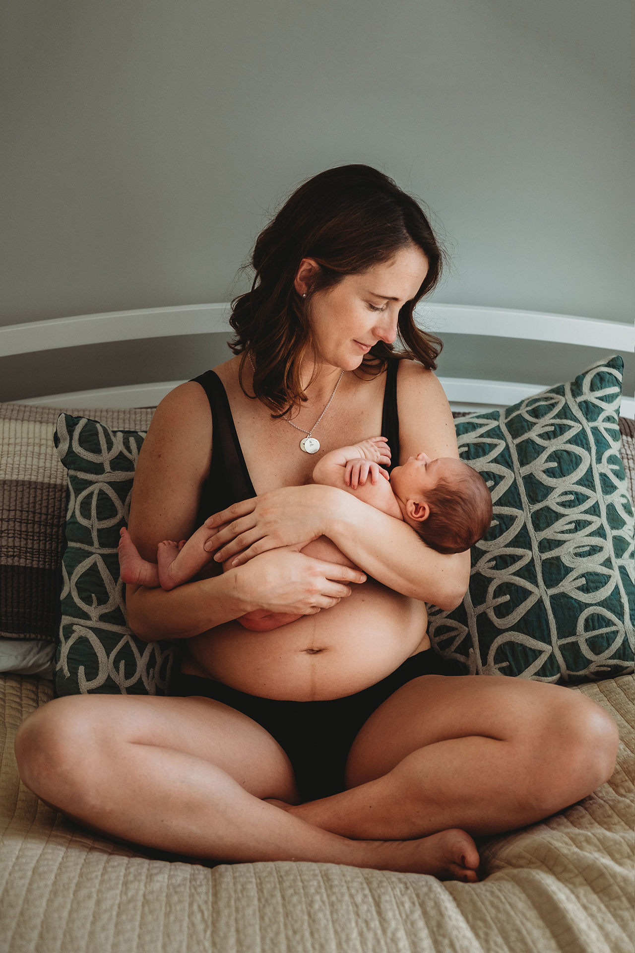 Best Maternity and Newborn Photographer Washington DC Maryland Virginia Mother sitting on bed with newborn