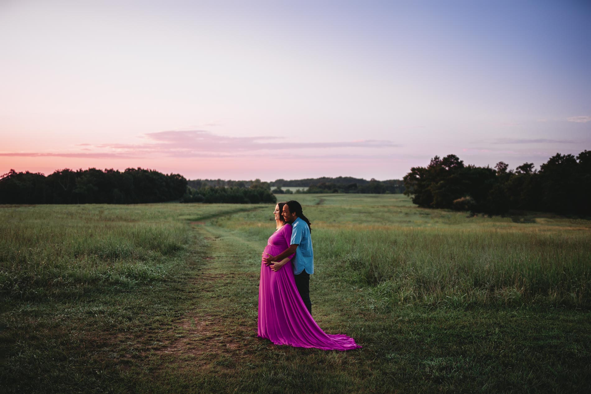 expecting couple in field at sunrise photographed by maternity photographer allison corinne